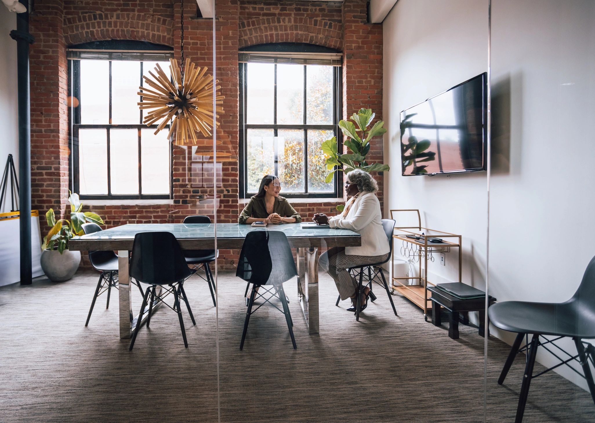 Two professionals in a one-on-one business coaching discussion